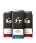 Three Peet's coffee bags with different flavors on a black background