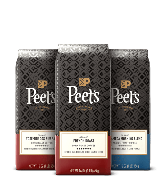 Three Peet's organic coffee bags with different blends on a black background